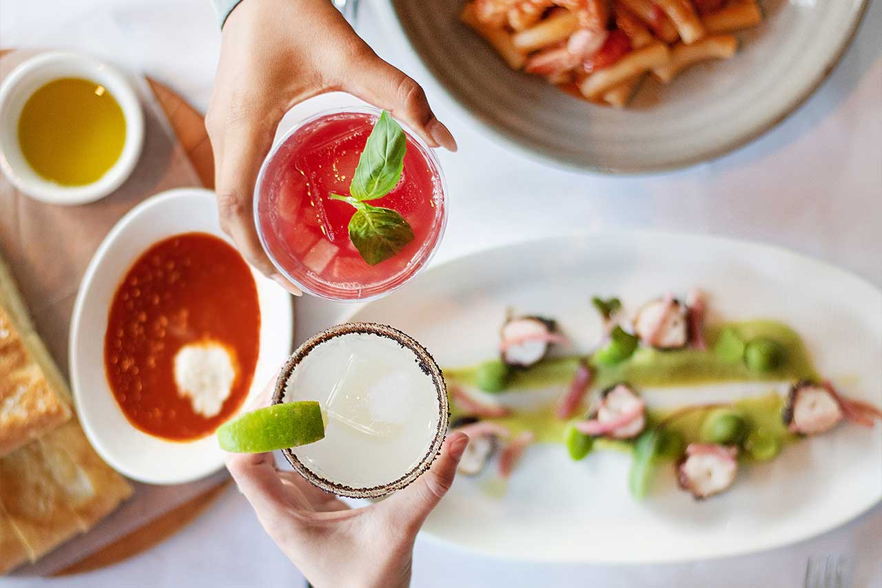 toasting cocktails over dinner plates
